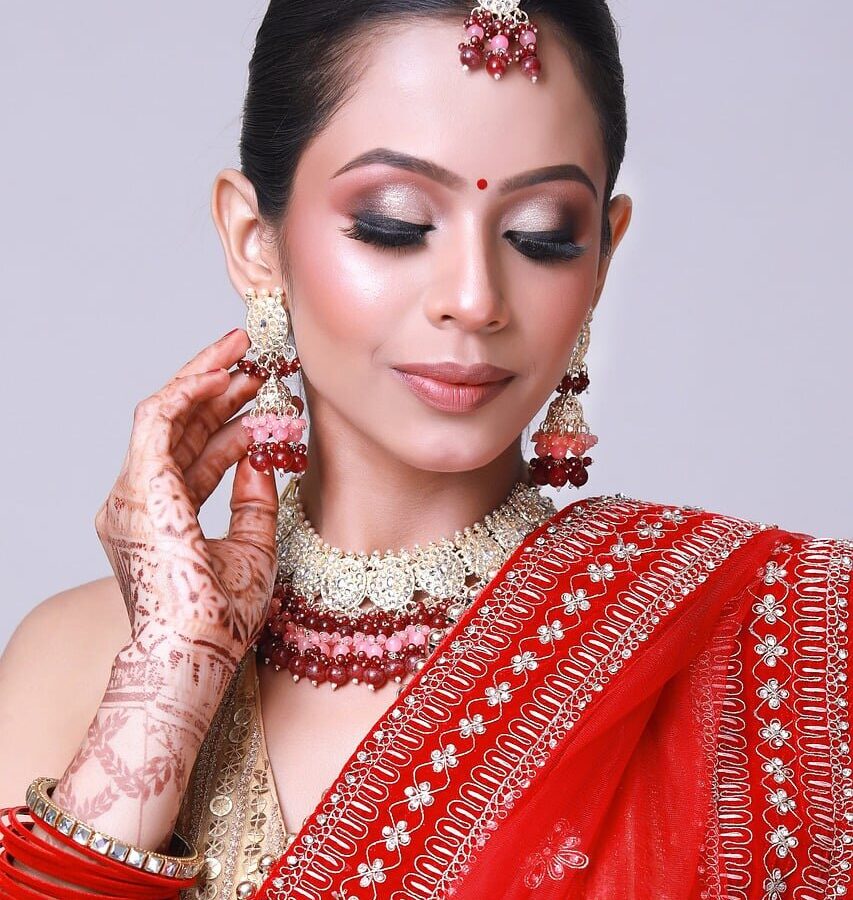 Bridal makeup application with elegant jewelry